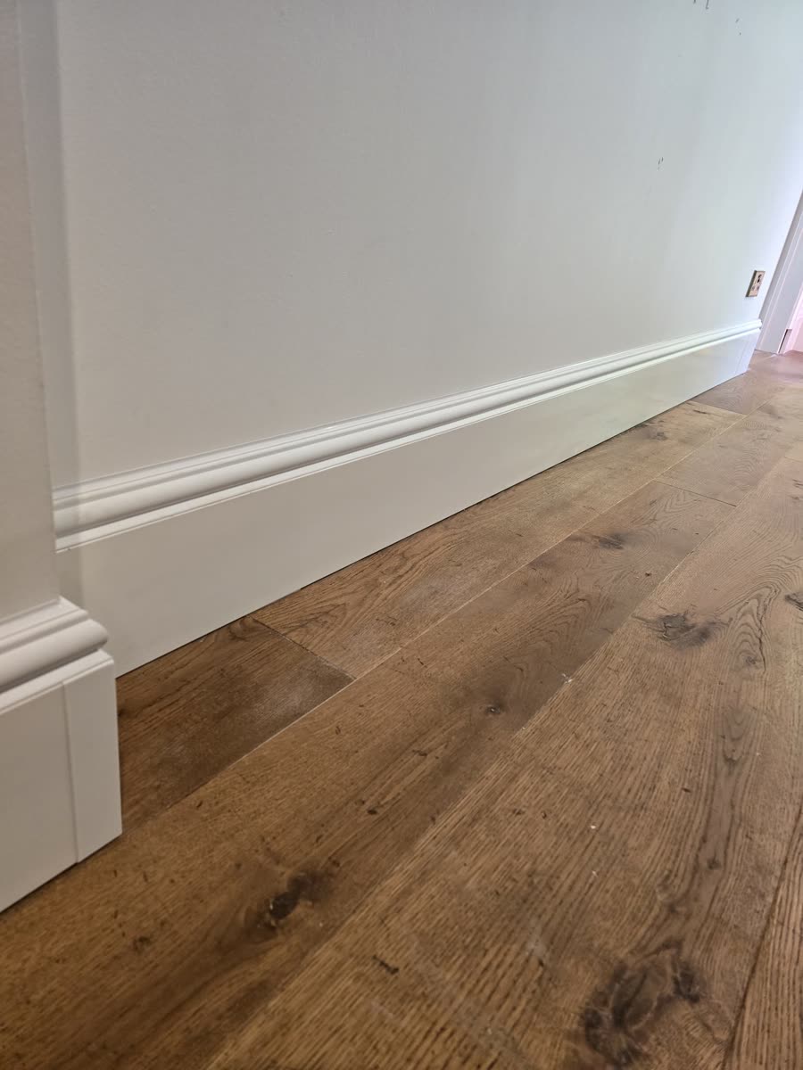 Torus-capped ThermaSkirt along an oak-floored hallway